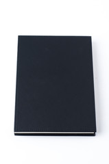 Black notebook on white background.