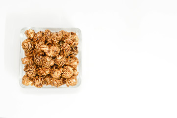 Homemade chocolate Popcorn in a glass Bowl and white background.