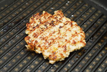 Hot Grilled  steaks are cooking on grill pan