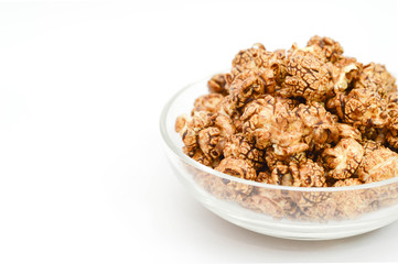 Image of chocolate popcorn in a glass bowl on white background a