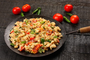 Homemade Scrambled eggs with herbs and vegetables.