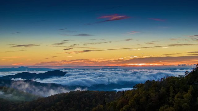 Early Morning Scene Overlooking from the Blue Ridge Parkway near Asheville NC with Fast Moving Mist and Clouds covering the Appalachian Mountain Peaks during the Fall