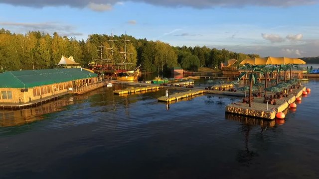 Aerial flying towards traditional Dutch sailing ship then moving around it drone boat moving slowly forward over the quiet water overcast weather grey cloud and not much wind classic medieval build 4k