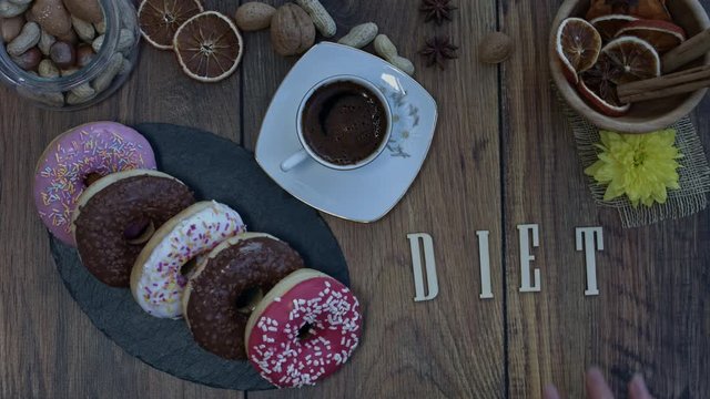 4k Donuts Composition on a Wooden Background with word Diet