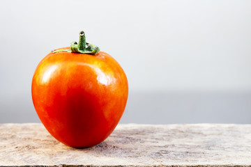 Red tomatoes on a wooden table.