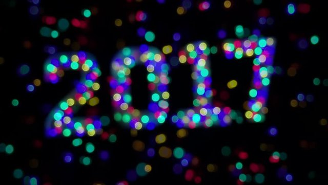 Glowing New Year 2017 message made from glowing light bokeh on dark background
