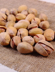 Pistachio nuts on white wooden table, healthy eating