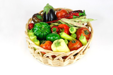 new picked fresh vegetables in basket isolated on white background