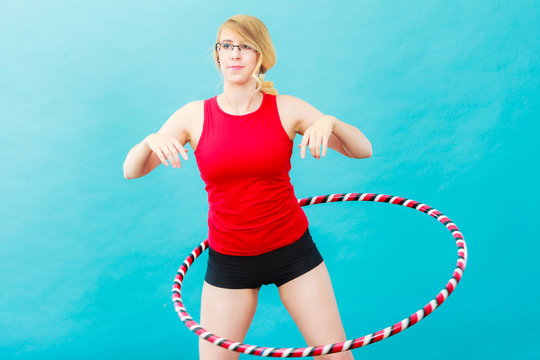 Fit woman with hula hoop doing exercise