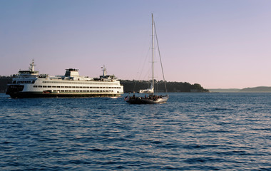 Ferry and sail boat head out of Elliott Bay and Puget Sound at Sunset