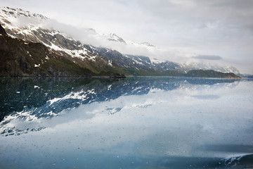 Mountains reflected in ice-strewn Tarr Inlet approaching Margerie Glacier, Alaska