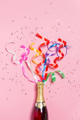 Flat lay of Celebration. Champagne bottle with colorful party st - obrazy, fototapety, plakaty