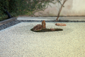 Zen gardens typically contain gravel and bare stones