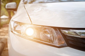 Headlight of a white car with halogen's rays