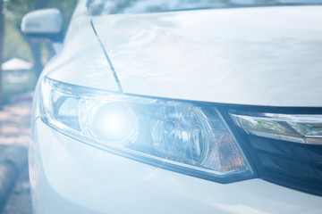 Headlight of a white car with xenon's rays