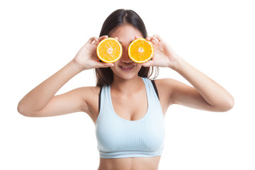 Beautiful Asian healthy girl with orange fruit over her eyes.