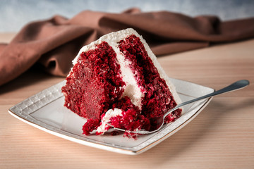 Slice of delicious red velvet cake on plate