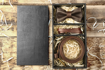 Luxury men outfits in black box on wooden background