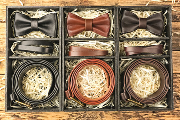 Luxury men outfits in black boxes on wooden background