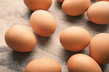 Raw eggs on wooden background