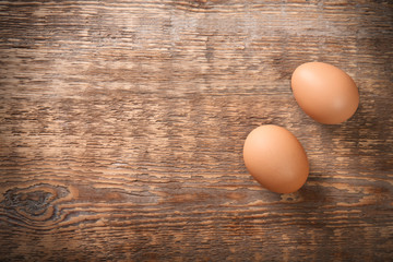 Raw eggs on wooden background