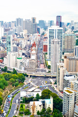 Naklejka premium Asia Business concept for real estate and corporate construction - vertical modern cityscape building bird eye aerial view from tokyo tower under sunrise and morning blue bright sky in Tokyo, Japan