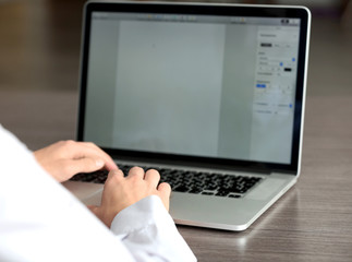 Businessman using laptop, close up