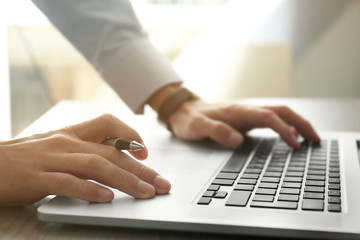 Businessman using laptop, close up