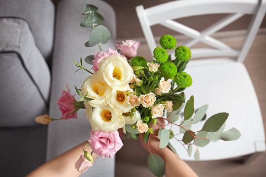 Closeup of female hands holding stylish bouquet of flowers