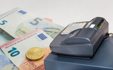Cash register and euro banknotes with 50 cent coin