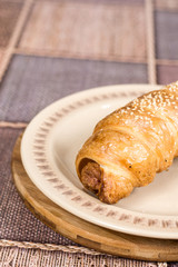 Puff pastry stuffed with sausages on the plate