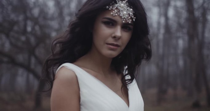 A young and beautiful bride looks into the camera sensually. 4k