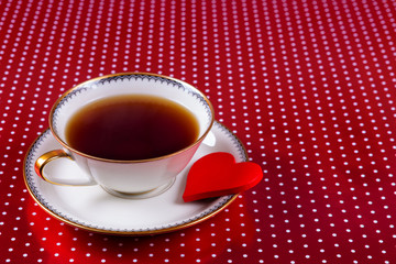 cup of tea and small red heart as a biscuit