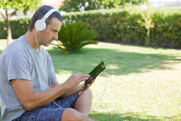 man relaxing with tablet pc