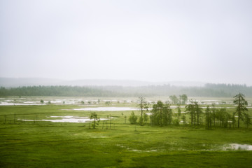 Fototapeta na wymiar A beautiful Finnish mire landscape from above - dreamy, foggy look