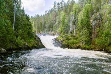 Fototapeta na wymiar A beautiful scenery with a river rapids in Finland