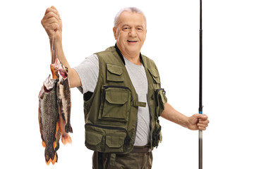 Happy mature fisherman with a fresh catch and fishing rod