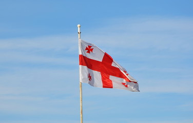 National Flag Of Georgia, Five Cross Flag, Waving On Flagpole At Blue Sunny Sky Background