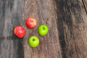 red and green apple on wooden background