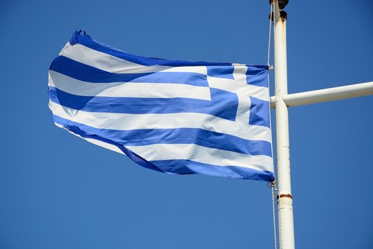 Greek flag against a blue sky, Crete.