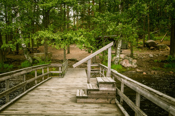 Fototapeta premium A beautiful lake landscape with footbridge in Finland