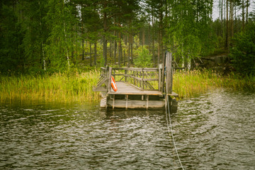 Obraz premium A beautiful lake landscape with footbridge in Finland