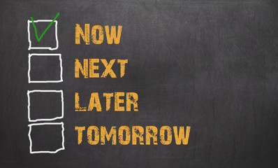 Do it now - business concept on blackboard