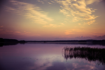 Fototapeta na wymiar A beautiful, colorful summer sunset over the lake in Finland