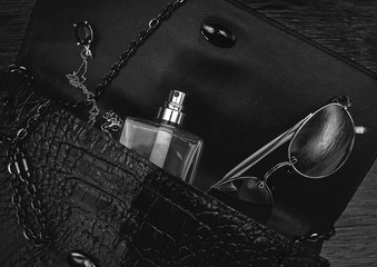 Top view of female fashion accessories. Perfume with sunglasses