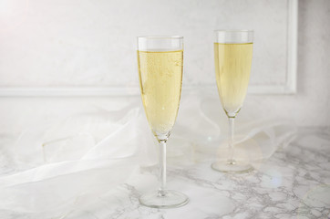 Glasses with New Year champagne on marble table.