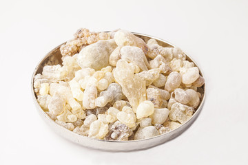 Frankincense in a plate, isolated in the white background