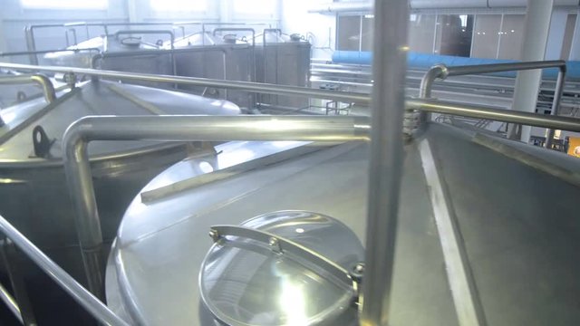 Production tanks, storages at a brewery. Pipline at a brewery factory. 4K.