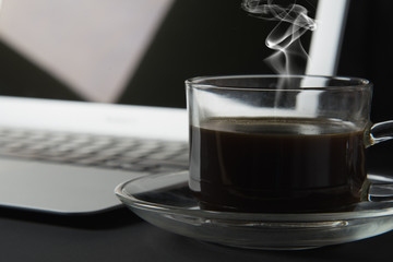 cup of coffee and laptop on the table