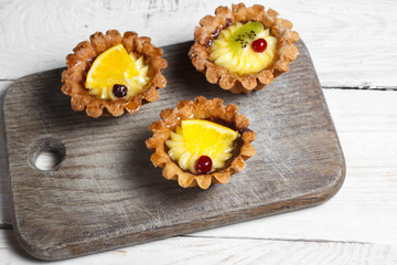 Homemade desserts with fruits for the new year. Desserts for the holidays. Side and top view. On a wooden background
